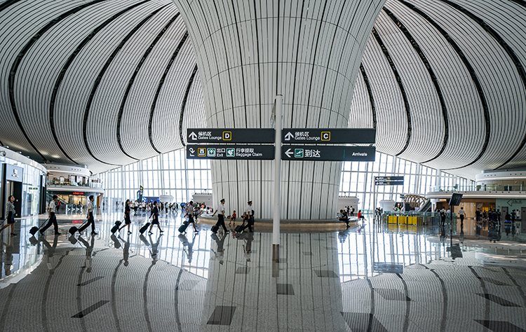8月30日,北京大兴国际机场,参加演练的机组人员走向登机口.