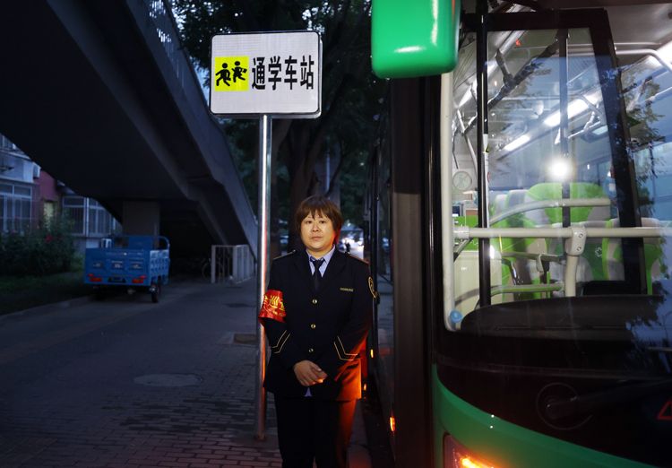 西路辅路双榆树东里附近的通学公交上车点,公交乘务员等待同学们乘车